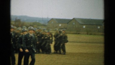 1952: military personnel matching in helmets at barracks. NEW HAMPSHIRE