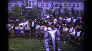 1953: young boys and girls ride a mechanical elephant ride as other children