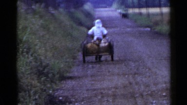 1953: a man pulling a cart on a long way to reach the destination JAPAN