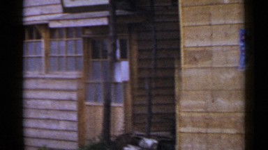 1953: view of an old wooden building panning from left to right. JAPAN