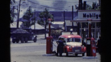 1953: different types of vehicles streaming through the road in a town JAPAN