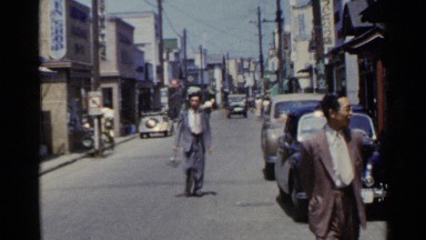 1953: people milling about on a street in a downtown area at daytime JAPAN