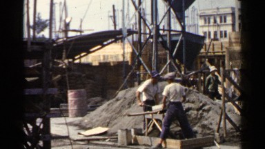 1953: workers are working hard for a construction work at the morning sunshine