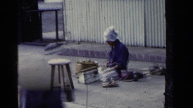 1953: the person stitching for the shoe and visit the people in the road side