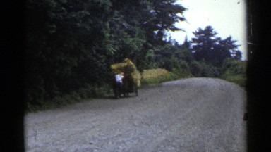 1953: a guy pushing a vehicle on the road at morning time. JAPAN