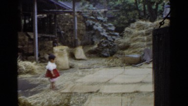 1953: a girl standing, child is looking straight, working area JAPAN