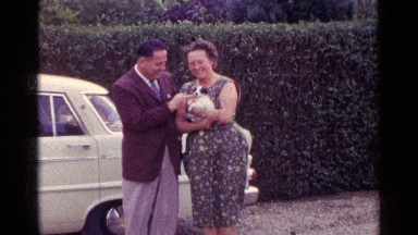 1961: the couple is happy to playing with the beautiful dog in her hands GERMANY