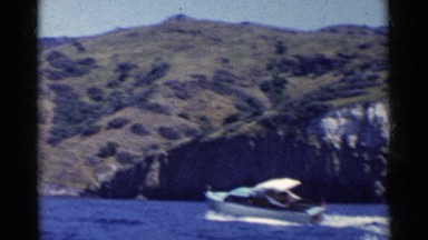 1955: Boating on Calm Waters Amidst California's Natural Scenery