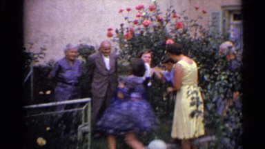 1961: small group of family members scurrying to pose for a photograph