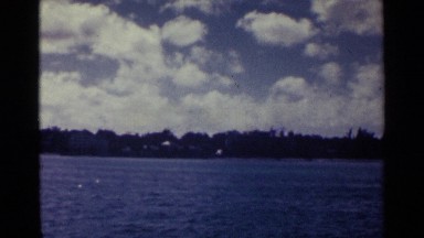 1963: Shining Blue Water in Moving Stream with Trees and Clouds in Nassau Bahamas