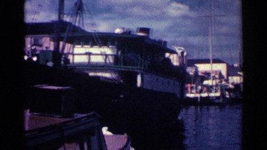 1963: many ships and boats remain anchored on the shore of the sea NASSAU