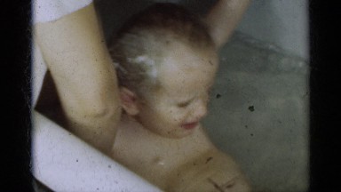 1939: A Cute Little Baby Struggling and Crying in a Bathtub of Water