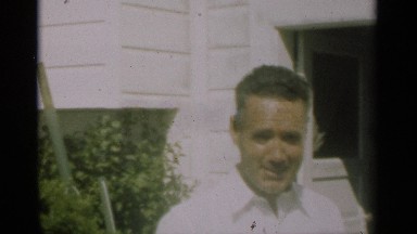 1949: a man with two women gave a pose for a video or photograph and talking