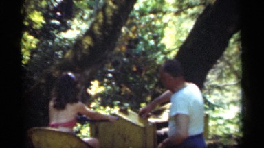 1949: a grandfather and his grand daughter are doing something on a machine