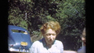 1949: an old happy couple standing hugged near to a parked sedan SANTA CRUZ