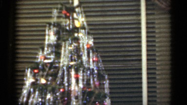 1949: old fashioned christmas tree with icicles, and string of lights