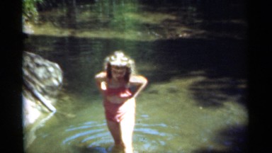 1949: girl afraid to take bath in river,girl walking in river, girl in a river