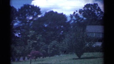 1959: a view of two beautiful white houses in a nice and well kept neighborhood