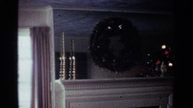 1959: camera panning on fireplace mantel decorated for christmas. OHIO