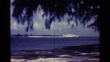 1963: Ships at Anchor Across a Blue Body of Water on a Cloudy Summer Day Nassau