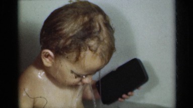 1939: the fair baby is taking bath with their mobile phone MICHIGAN
