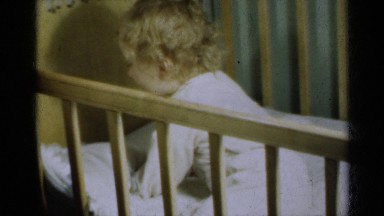 1939: adorable toddler fights off sleep in her crib. MICHIGAN