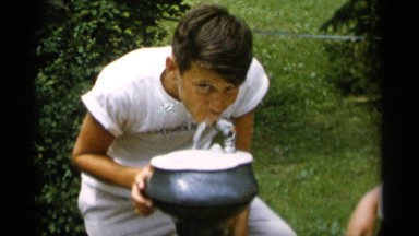 1956: family drinks out of water fountains in a park. JONES BEACH NEW YORK