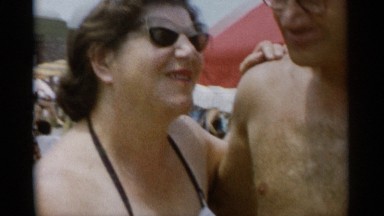 1956: a couple dance in bathers on a sun drenched beach. JONES BEACH NEW YORK