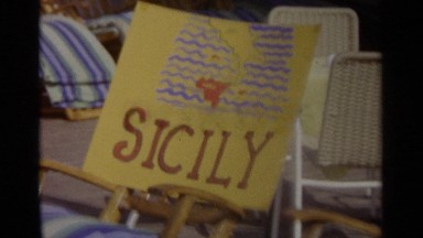1965: A Wooden Name Board on a Chair in Outdoor Sicily