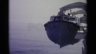 1965: people watch as a life boat is slowly lowered into the ocean
