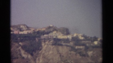 1965: sea water near the mountain, rocks on top SICILY