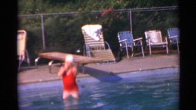 1967: A Lady in Red Swimsuit Jumping into Pool in US Virgin Islands