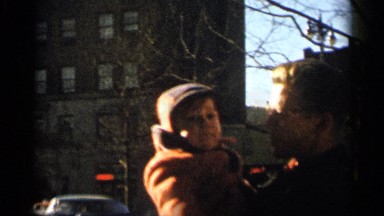 1955: a man holding a baby child in the hand and standing NEW YORK CITY