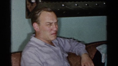 1955: a man talking with his family members about the shoes of their kid