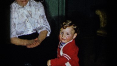 1955: a mother claps and taking care of a small kid at her home. NEW YORK CITY