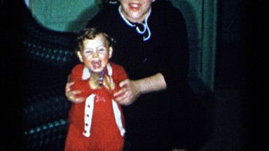 1955: a mom playing with her little cute baby dressed in red and white NEW YORK