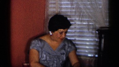 1955: person in grey dress applying perfume by hand to smell good NEW YORK CITY