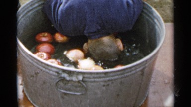 1954: a boy pushing his head inside the water for making him cool . NEW YORK