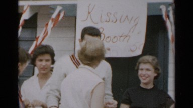 1954: peoples are so excited and kissing because of kissing booth NEW YORK