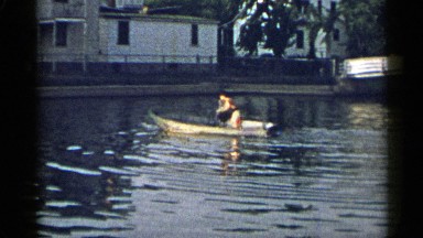 1954: a small boy drove a boat with fin by lonely without any one's help