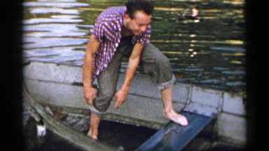 1954: father and sons enjoy some time on the lake paddling in their canoe