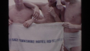 1954: people are enjoying in beach with flag NEW YORK