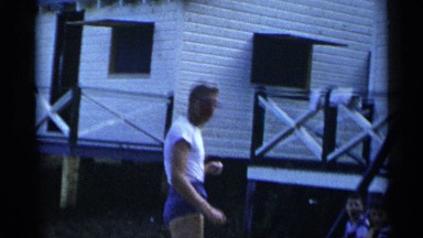 1954: two boys being coached by scantily clad man to throw baseball NEW YORK