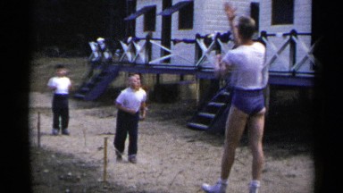 1954: children are playing with a men very happily outside their house NEW YORK