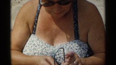 1954: Old Lady Weaving on Beach in New York Morning