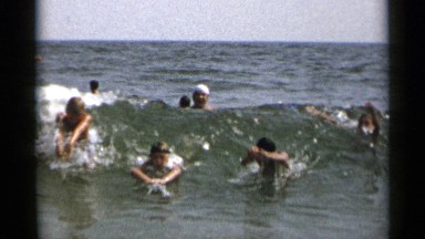 1954: a group of people playing and enjoying in sea and in a very happy mood
