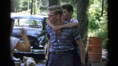 1954: a young man gives a younger boy a piggyback ride. NEW YORK