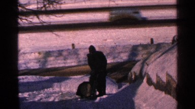 1965: a man pulling a water machine and spread out the water at the steps