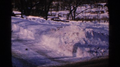 1965: busy road with snow banks and frozen trees. MINNESOTA