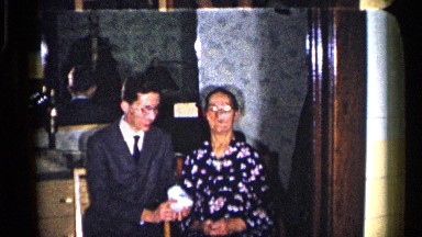 1960: the women take hand near to men speak the women and men near screen door